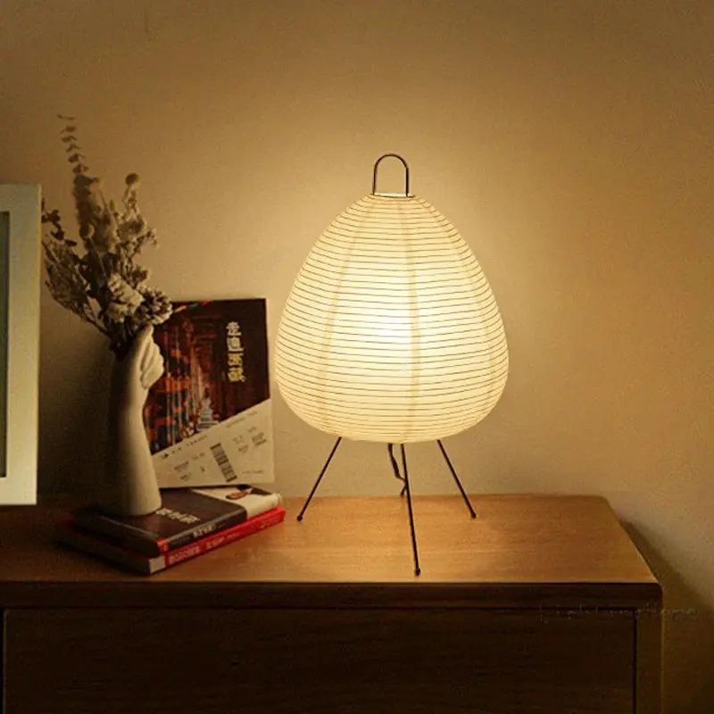 Minimalist Japanese rice paper lamp with three-legged frame and soft warm LED light