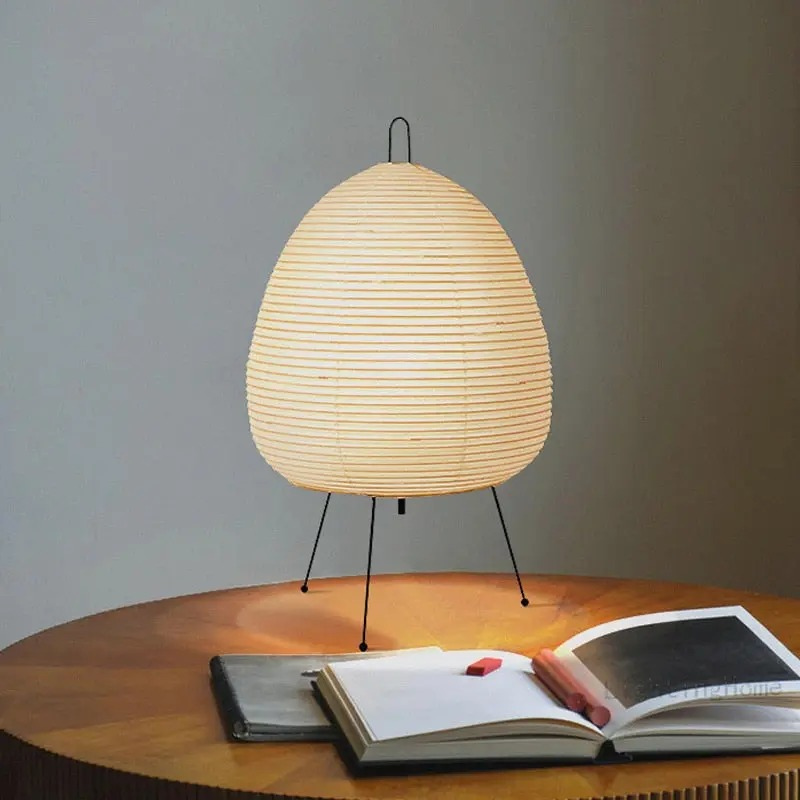 Minimalist Japanese rice paper lamp with three-legged frame and soft warm LED light