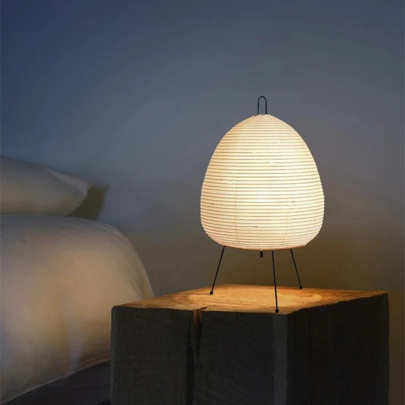 Minimalist Japanese rice paper lamp with three-legged frame and soft warm LED light