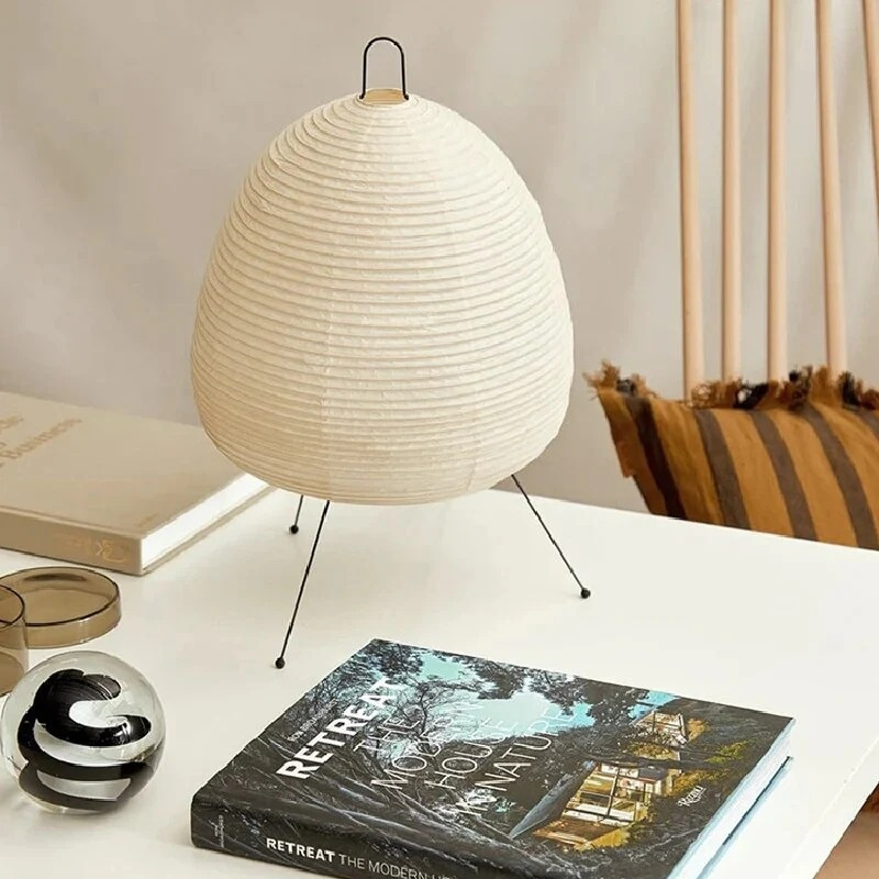 Minimalist Japanese rice paper lamp with three-legged frame and soft warm LED light