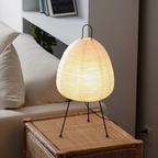 Minimalist Japanese rice paper lamp with three-legged frame and soft warm LED light