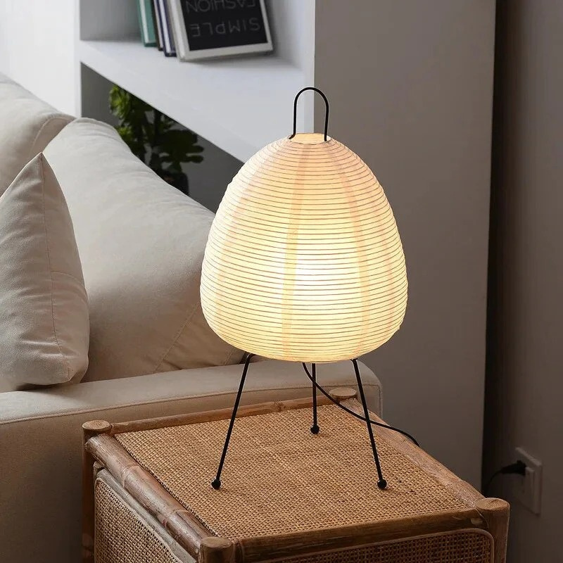 Minimalist Japanese rice paper lamp with three-legged frame and soft warm LED light