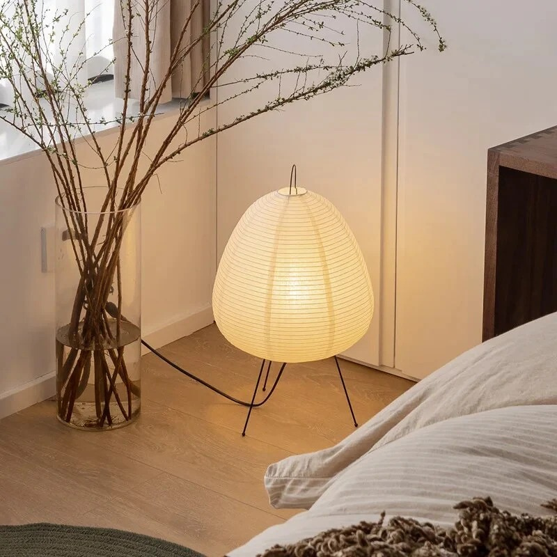 Minimalist Japanese rice paper lamp with three-legged frame and soft warm LED light