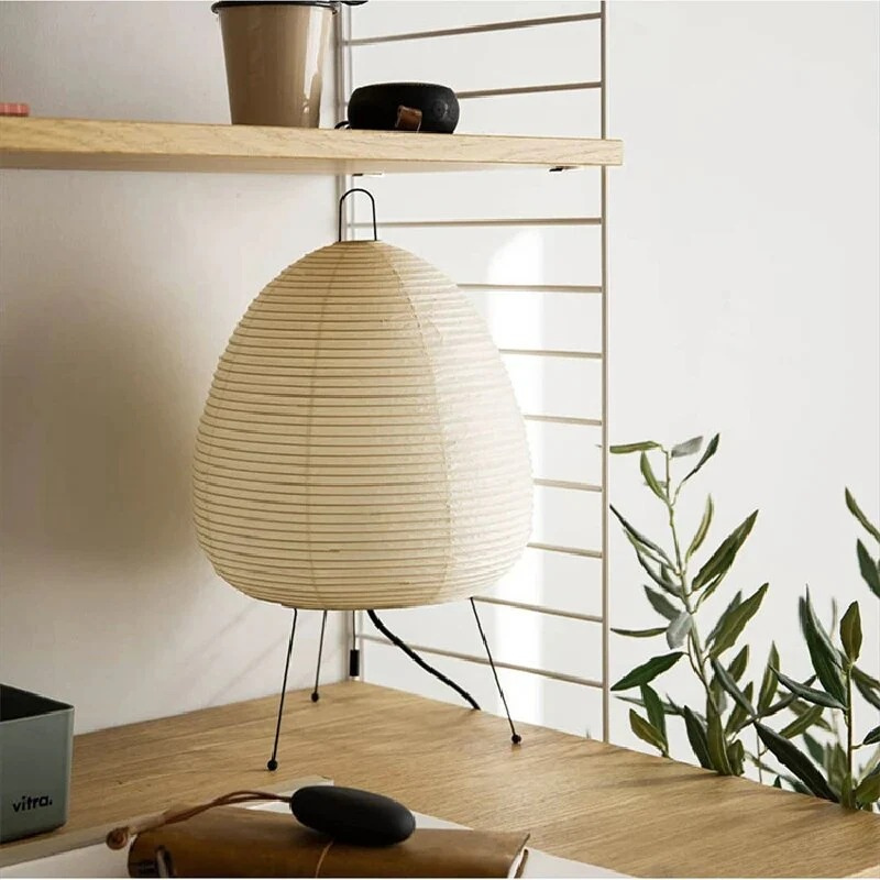 Minimalist Japanese rice paper lamp with three-legged frame and soft warm LED light