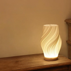 Compact sculptural LED swirl lamp with warm dimmable glow and USB power