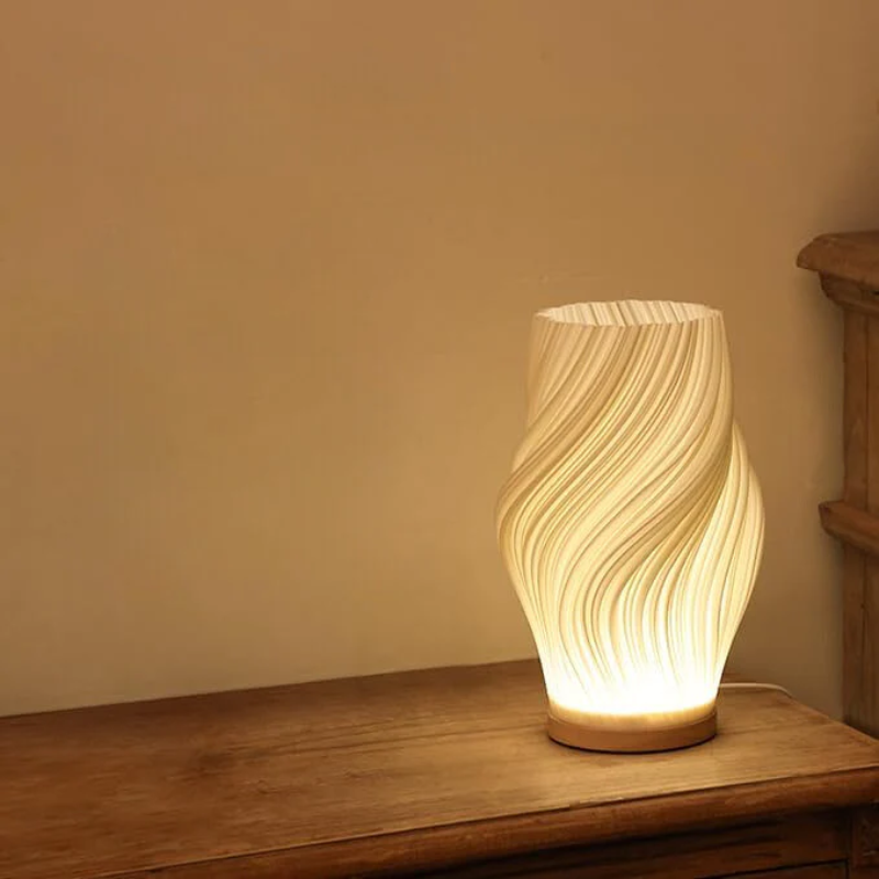 Compact sculptural LED swirl lamp with warm dimmable glow and USB power
