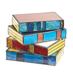 Stained glass table lamp in the shape of an open book with warm glowing light
