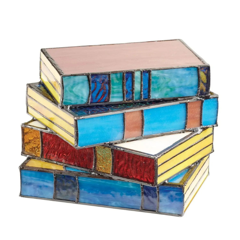 Stained glass table lamp in the shape of an open book with warm glowing light