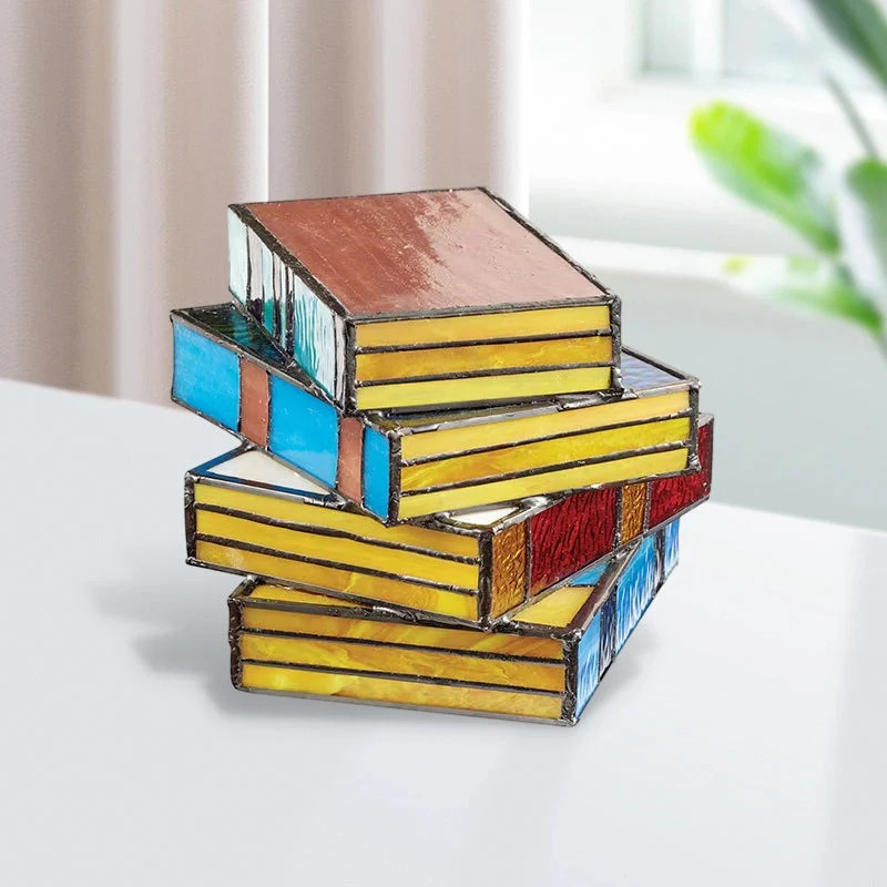 Stained glass table lamp in the shape of an open book with warm glowing light